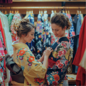 A woman from abroad getting dressed in a kimono