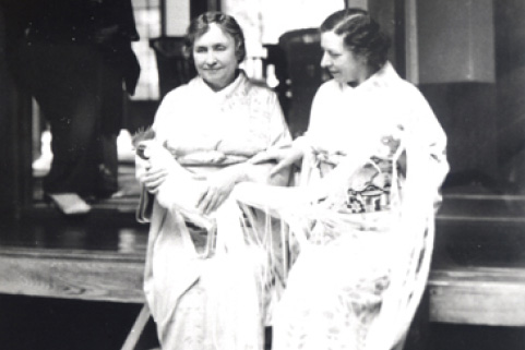 A black-and-white photograph of Helen Keller and another woman, both dressed in traditional Japanese clothing, sitting side by side